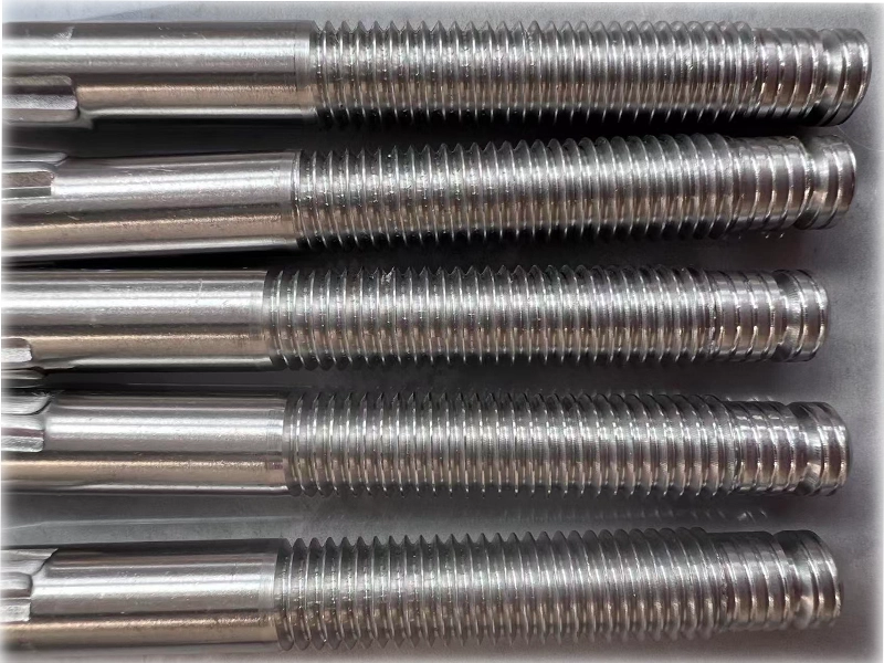Long stainless steel shaft threading on CNC lathe, showing the challenge of chatter and deflection in slender workpieces.